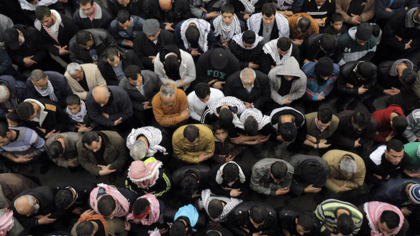 People pray during the funeral of 20-year-old Palestinian man Jihad al-Jaafari in the West Bank city of Bethlehem February 24, 2015. Israeli soldiers shot dead al-Jaafari in the occupied West Bank on Tuesday, the military and a Palestinian hospital official said. Residents of the Deheishe refugee camp in Bethlehem said Palestinians threw stones at Israeli soldiers who had entered the area and the troops opened fire. An Israeli military spokeswoman said the Palestinians hurled rocks, blocks and firebombs at